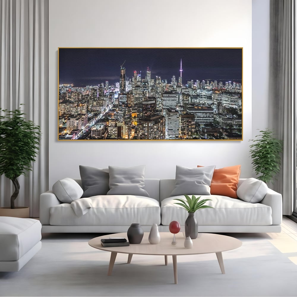 Tablou canvas cu panoramic nocturn cu toronto si cn tower, in rama de aluminiu auriu, pe perete intr-un living